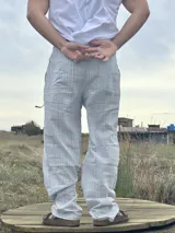 Pantalón celeste y crudo a rayas, tipo lino, de corte recto y relajado.