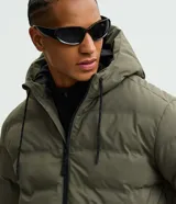Campera puffer deportiva Get Over, color negro, con diseño sin costuras, cierre frontal por cremallera y capucha con cordón ajustable. Presenta puños elásticos y diseño acolchado.