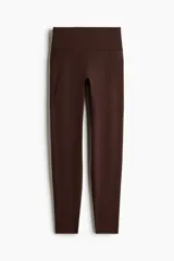 Leggings deportivos de talle alto en color marrón, confeccionados con tejido funcional DryMove y SoftMove con bolsillos abiertos en las piernas.
