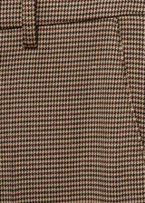 Pantalón de tiro medio color marrón con diseño a cuadros pequeños (pata de gallo), de corte ajustado y largo crop. Cuenta con bolsillos laterales, trabillas para cinto y cierre frontal oculto.