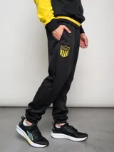 Pantalón deportivo negro con logo del Club Atlético Peñarol en amarillo.