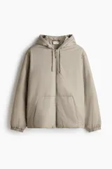 Campera acolchada de tejido funcional repelente al agua y rompevientos, color gris claro, de corte holgado con capucha ajustable, cierre frontal, bolsillos delanteros y puños elastizados.