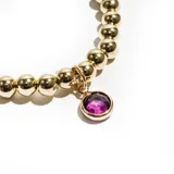 Pulsera dorada con cuentas esféricas y dije colgante redondo con piedra amatista.