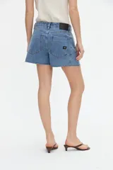 Short de jean de tiro alto con diseño pinzado, corte relajado, bolsillos delanteros y botamanga con terminación deshilachada.