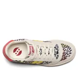 Championes Saucony Jazz Court de cuero y tela con estampado animal print multicolor, detalles en amarillo y suela de goma color crema con línea roja.