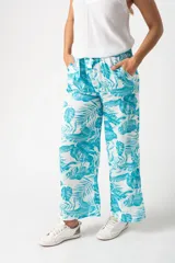 Pantalón palazo turquesa con estampado de hojas, cintura elastizada con lazo y corte amplio.