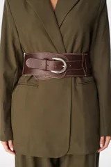 Faja ancha de cuero texturizado en color marrón, con diseño envolvente y hebilla metálica plateada.