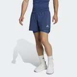 Short deportivo Adidas 2 en 1 para running, confeccionado en tejido liso de poliéster reciclado. Cuenta con calzoncillo interior de malla, cintura elástica con cordón de ajuste, bolsillos laterales y detalles reflectantes.