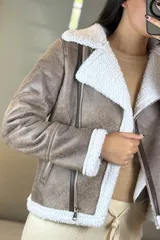 Campera tipo gamulán de cuero sintético negro con interior y solapas de corderito blanco. Presenta cierre frontal cruzado y bolsillos laterales con cierre.
