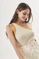 Top tejido color crema con rayas verticales y ribete amarillo en el escote asimétrico.