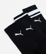 Kit de tres pares de medias deportivas Puma de caña larga, color blanco con detalles en negro. Incluye logo de la marca y diseño con rayas en la parte superior.