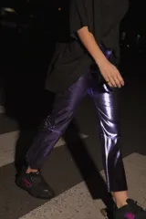 Pantalón capri semi oxford de ecocuero violeta, con tiro medio-alto, botón metálico níquel y bolsillos traseros.