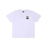 Remera blanca de algodón con cuello redondo y manga corta. Estampado pequeño en el pecho con diseño abstracto en blanco y negro con detalles en naranja.