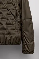 Cazadora deportiva acolchada color verde oscuro, con cuello alto y cierre frontal con cremallera. Cuenta con bolsillos laterales con cremallera oculta y un bolsillo interior.