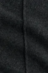 Buzo oversized de punto suave, color gris oscuro, con cuello alto acanalado y abertura trasera en V. Presenta costuras decorativas verticales y hombros caídos con mangas largas.