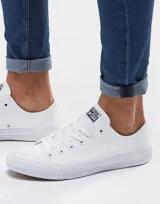 Championes Converse modelo Chuck Taylor All Star en versión monocromática blanca. Diseño clásico de caña baja con capellada de lona, puntera de goma y suela vulcanizada.