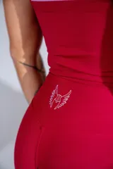 Calza deportiva de tiro alto en color bordó, confeccionada en tejido elástico con diseño sin costuras.