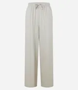 Pantalón de corte holgado y fluido, color negro, con cintura elástica y lazo ajustable. Confeccionado en una mezcla de viscosa y lino.