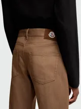 Pantalón de jean recto color marrón claro, con tiro medio y cinco bolsillos.