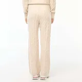Pantalón de punto con diseño de trenzas, color beige, de corte recto y holgado. Cuenta con cintura elástica con cordón ajustable.