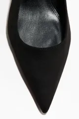Zapatos de tacón tipo kitten heel destalonados, de color negro, con punta fina, tira elástica en el talón y forro de satén.