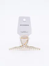 Pinza para el pelo color blanco con borde dorado.