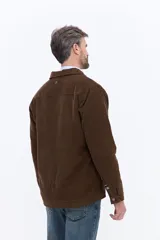 Campera de pana color azul marino con textura acanalada, cierre frontal con botones a presión, cuello clásico y ajuste regular.