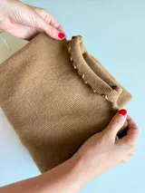 Pack de tres poleras de tejido de punto fino, con cuello alto y terminaciones con borde ondulado. Incluye tres unidades en colores natural, bordó y dulce de leche.