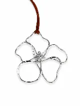 Collar con dije en forma de flor abstracta de metal plateado, suspendido de un cordón de cuero marrón.