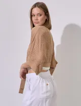 Bolero calado negro de poliéster con mangas 3/4 y frente abierto con lazo.