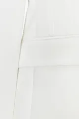 Blazer entallada color blanco, con cuello solapa combinado, manga larga con hombreras, bolsillos de plastrón en delantero, detalle de costuras marcadas, forro interior a tono y cierre frontal con botón forrado en mismo material.