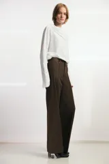 Camiseta de manga larga confeccionada en mezcla de algodón y lino, con cuello redondo y detalle de superposición tipo pañuelo en el mismo tejido.