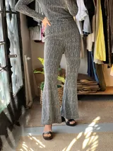 Pantalón plateado de tiro alto con textura y corte acampanado.