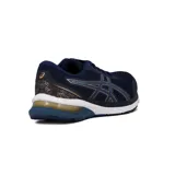 Championes de running Asics modelo Gel-Shogun 4, color azul marino con detalles en dorado y entresuela blanca.