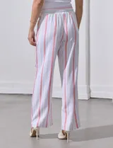 Pantalón de lino de la marca Marissa Olivia, con pretina ancha elastizada y lazo de ajuste. Diseño a rayas verticales en blanco, rojo y azul. Cuenta con bolsillos inclinados en la parte delantera.