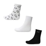 Pack de tres pares de medias de media caña. Incluye un par blanco con estampado de caritas felices negras, un par blanco liso y un par negro con una pequeña carita feliz bordada en el tobillo.