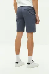 Bermuda de gabardina color gris con logo bordado, bolsillos laterales y traseros, cierre con cremallera y pasacintos.