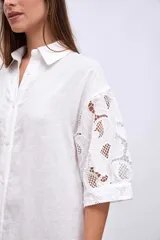 Vestido camisero blanco de lino con mangas cortas abullonadas de encaje y corte midi.