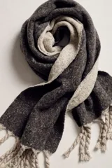 Bufanda de tejido melange en color marrón oscuro con reverso y flecos trenzados en tono beige.