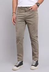 Pantalón de gabardina color beige, corte recto, con cinco bolsillos y cierre con botón y cremallera.