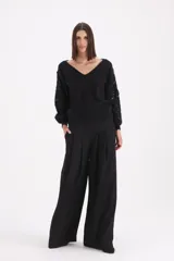 Pantalon de corte ancho y tiro alto, con pinzas frontales que aportan volumen y caída fluida.