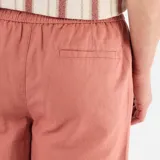 Bermuda de lino mezclado color rosa, de corte clásico con bolsillos laterales y traseros, y cierre con botón y cremallera.