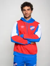 Canguro de felpa Umbro del Club Nacional de Football, con diseño tricolor en rojo, azul y blanco. Presenta capucha con cordones ajustables, bolsillo tipo canguro frontal, logo de la marca y escudo del club bordados en el pecho.