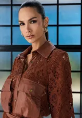 Camisa de cuero marrón con mangas de encaje al tono, cuello clásico, cierre frontal con botones y bolsillos delanteros con solapa.