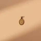 Dije de forma ovalada con la imagen de la Virgen Milagrosa en relieve, fabricado en plata 925 con baño de oro.