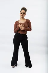 Pantalón oxford negro con costuras frontales y aberturas en el ruedo.