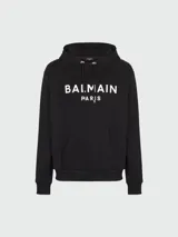 Buzo hoodie negro de algodón con logo Balmain Paris estampado en blanco en el frente.