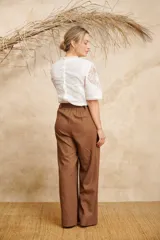 Camisa blanca de manga corta con aplicaciones de guipur en el frente y en las mangas.