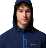 Campera técnica Columbia con capucha ajustable, confeccionada en tejido softshell azul marino con tecnología Omni-Shield. Presenta cierre frontal y bolsillo en el pecho con detalles en azul vibrante, además de bolsillos laterales con cierre y puños elásticos.