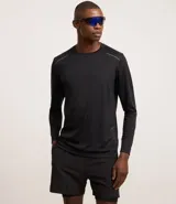 Remera deportiva de manga larga para hombre, color negro, con cuello redondo y detalles reflectantes en los hombros. Confeccionada en tejido Dry Fit (malla) de poliéster.